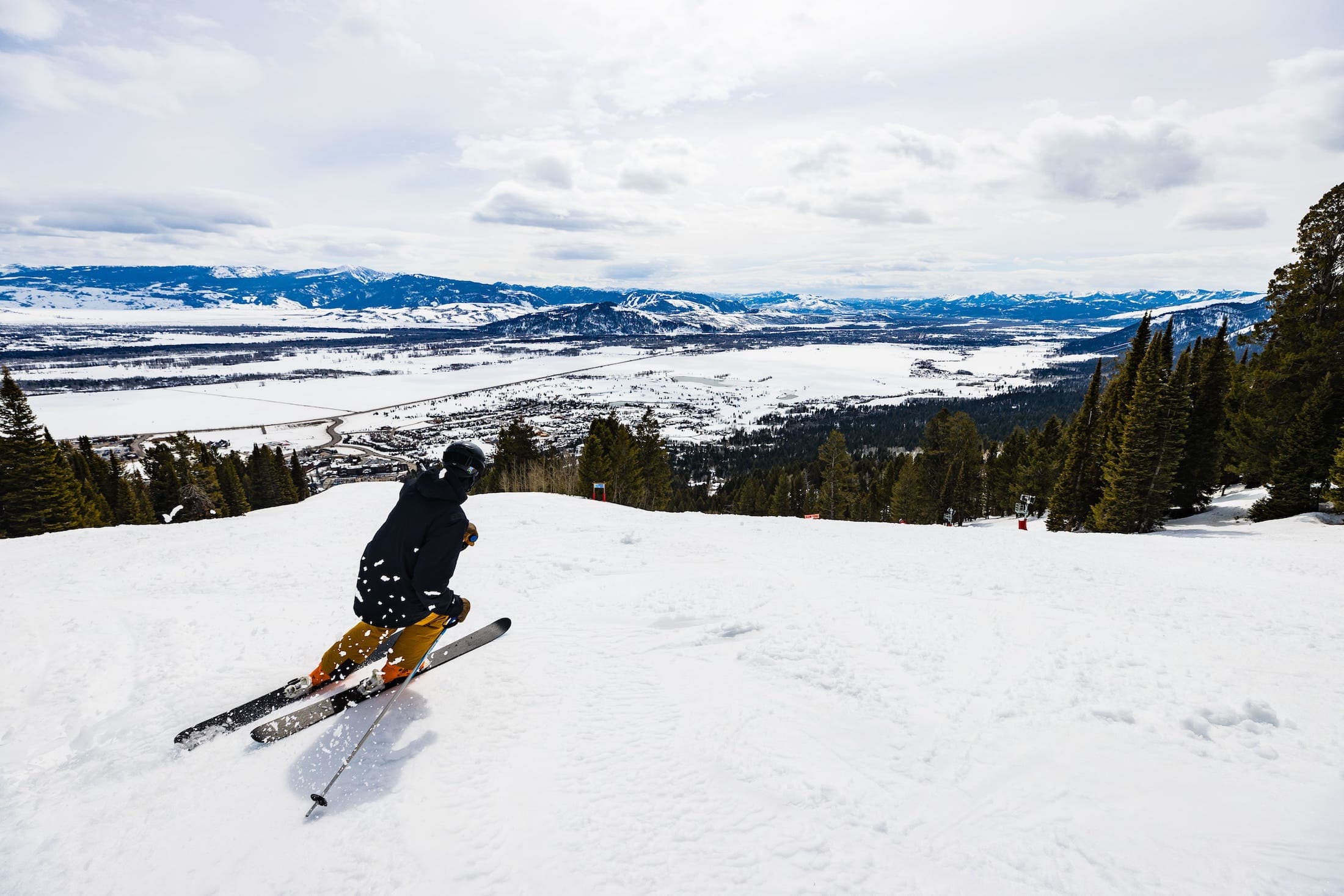 A downhill skier skiing down the mountain at Teton Mountain Lodge