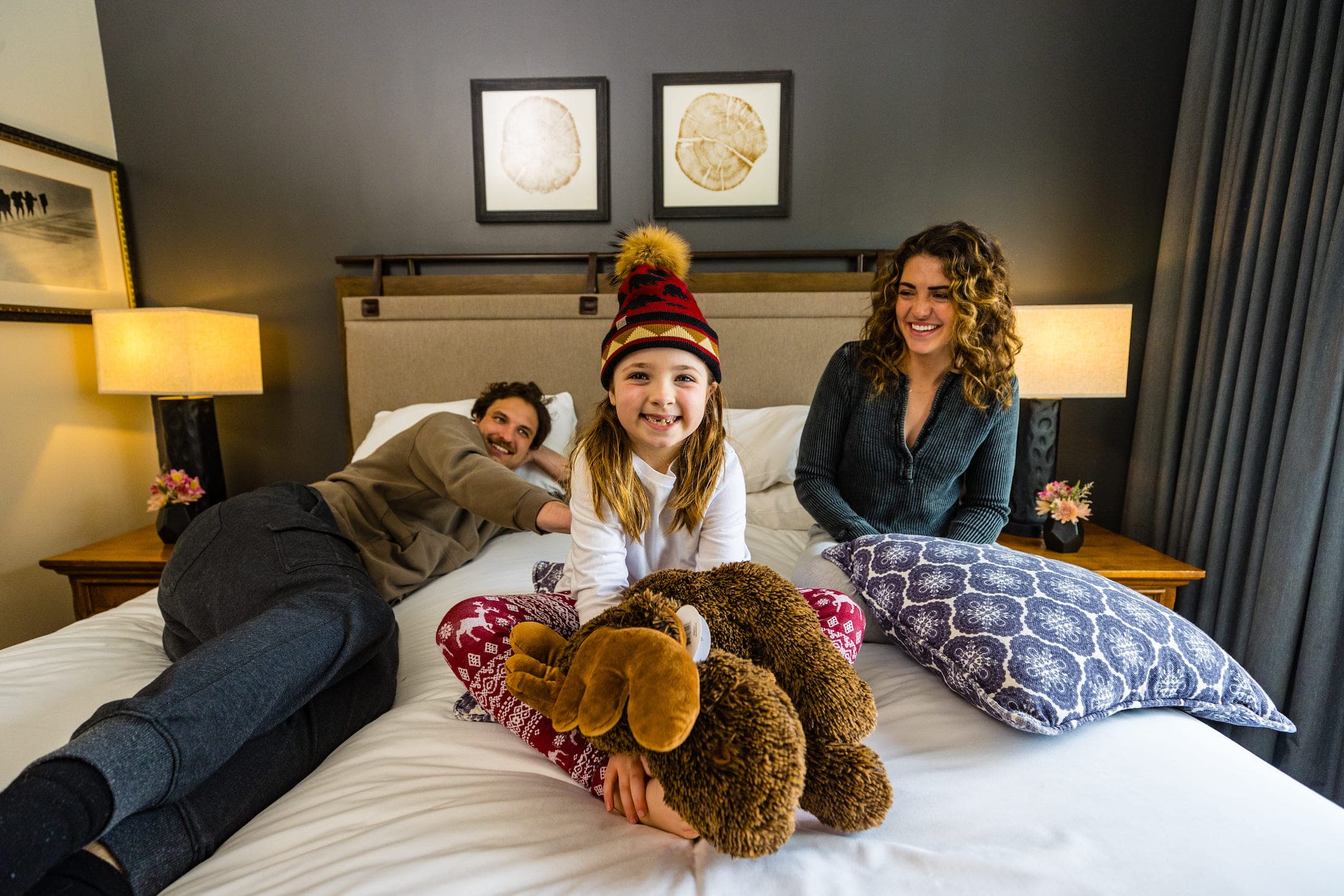 A family on a queen bed at Teton Mountain Lodge