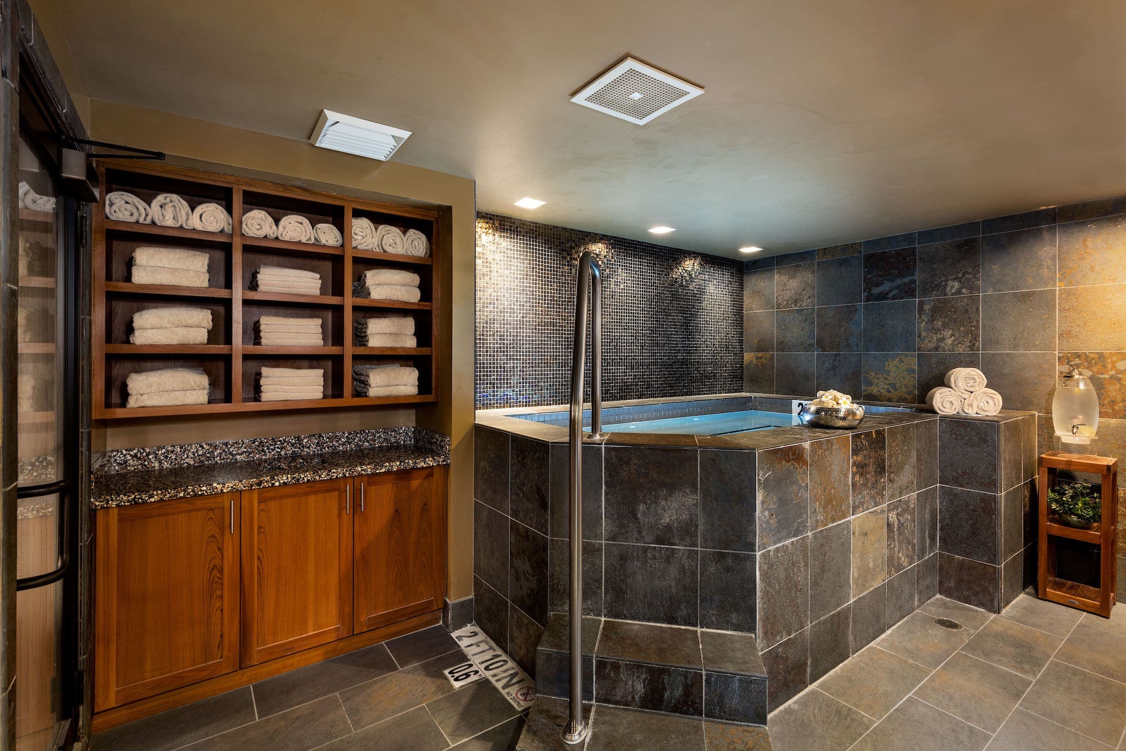 A SpaTerre hot tub room with a wall of towels