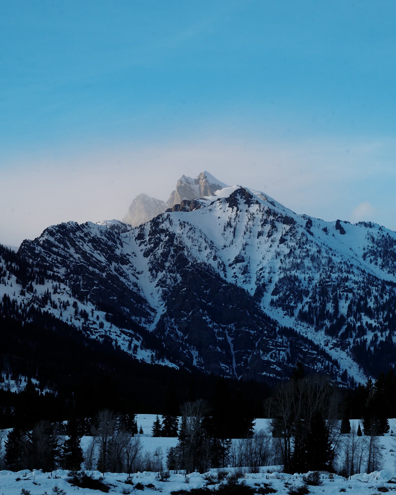 A photo of the Tetons during the evening