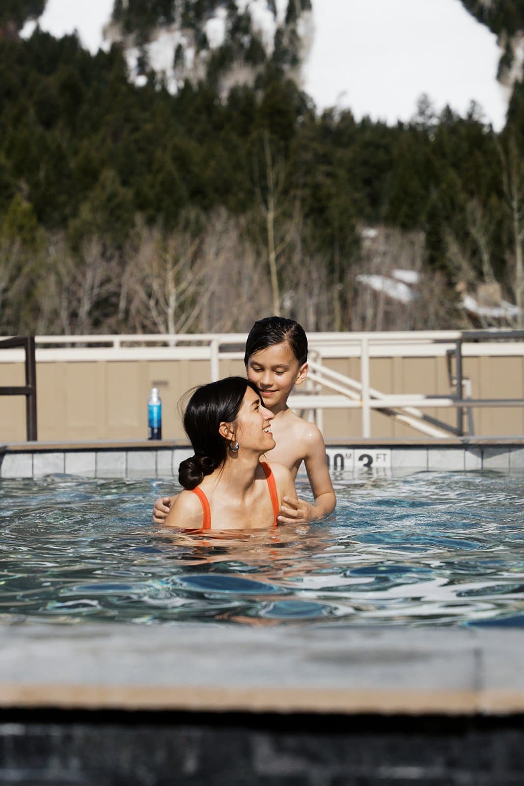 Two people outside in an outdoor pool