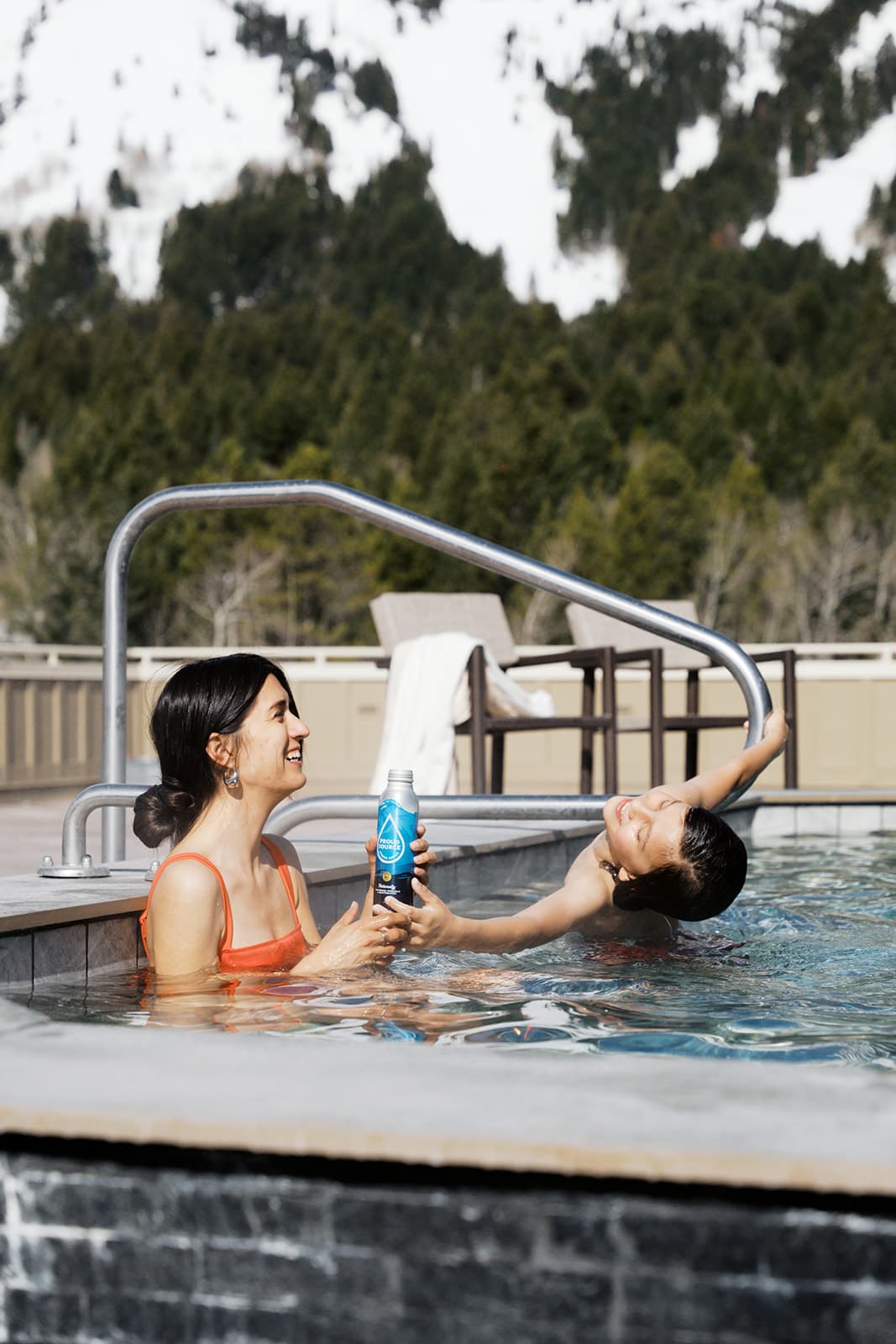 Two people enjoying an outdoor pool