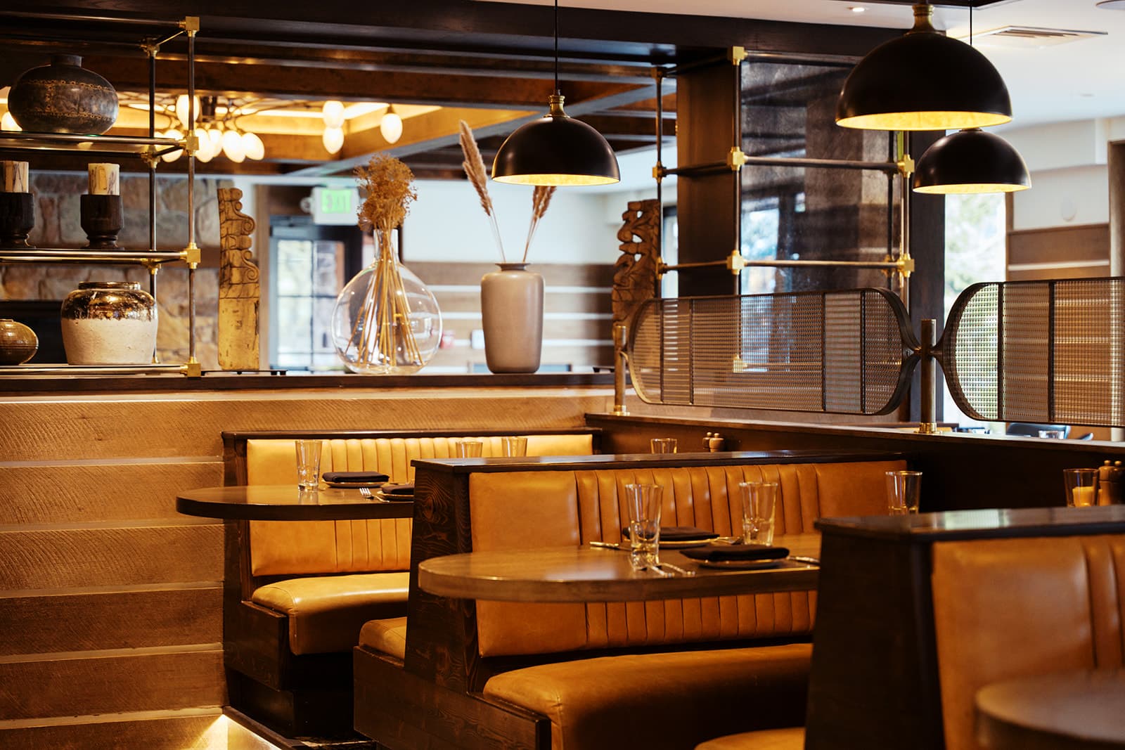 A photo of multiple restaurant booths with warm lighting