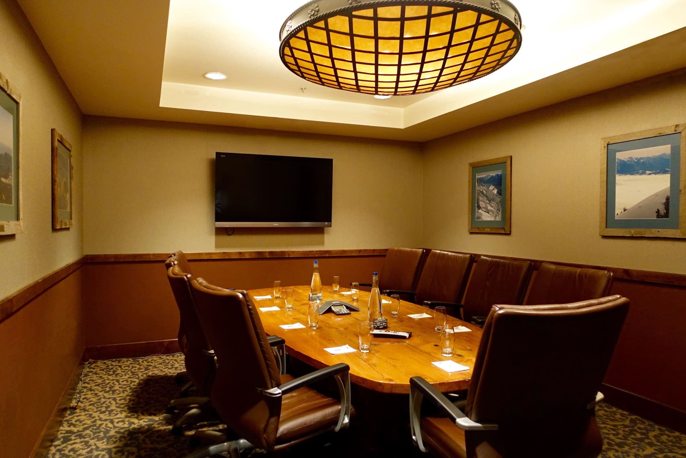 One beautiful oval table with 9 brown leather chairs in a boardroom at Teton Mountain Lodge