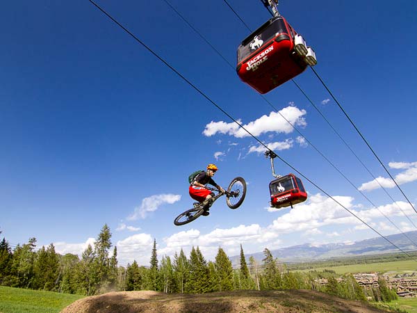 Mountain Biker Jumping Under The Jackson Hole Tram.