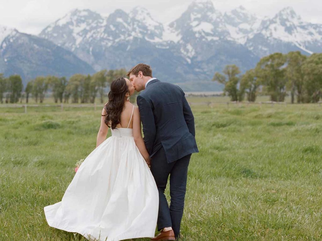Wedding couple walking in field