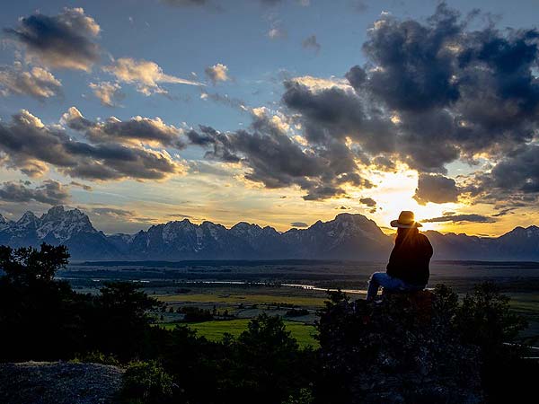 woman looking at panorama of Tetons