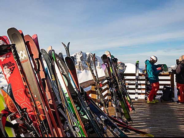 Skis set up on a railing.