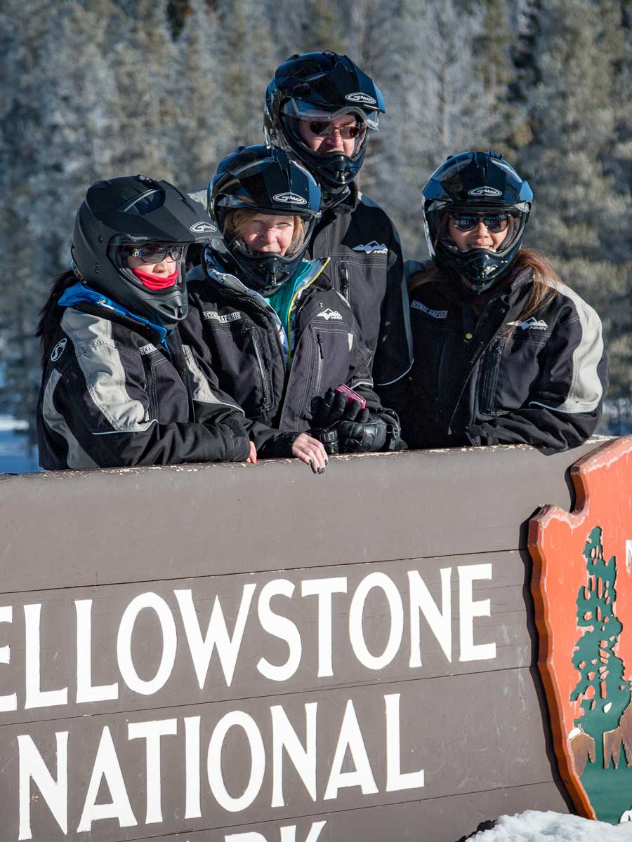 Family In Front Of The Yellowstone Sign.