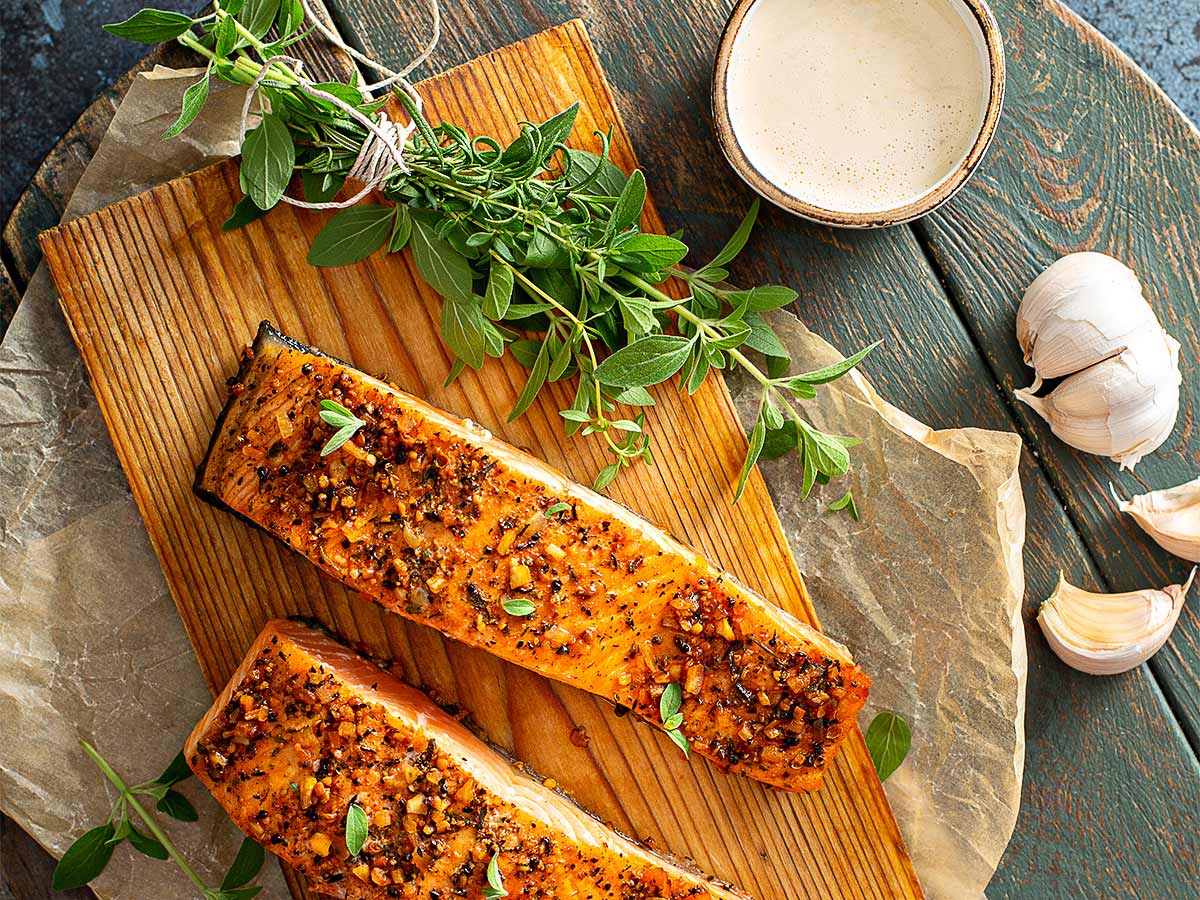 Salmon And Herbs On A Wood Plank.