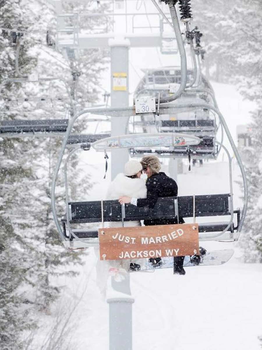 Bride And Groom Riding The Ski Lift.